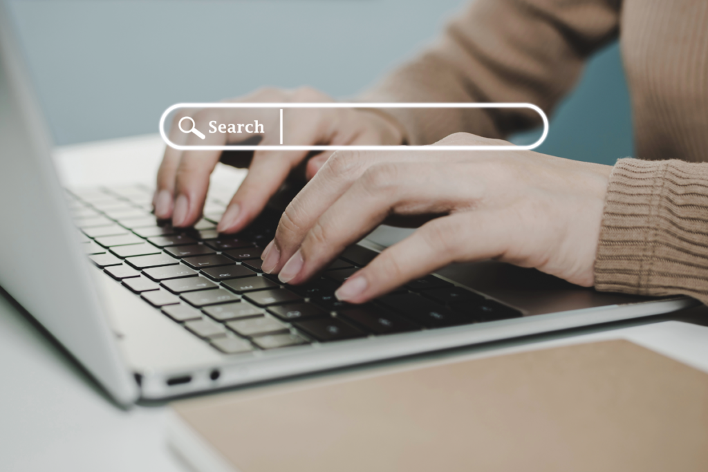 Person typing a search query on laptop illustrating SEO for Perplexity and AI answer-based search.